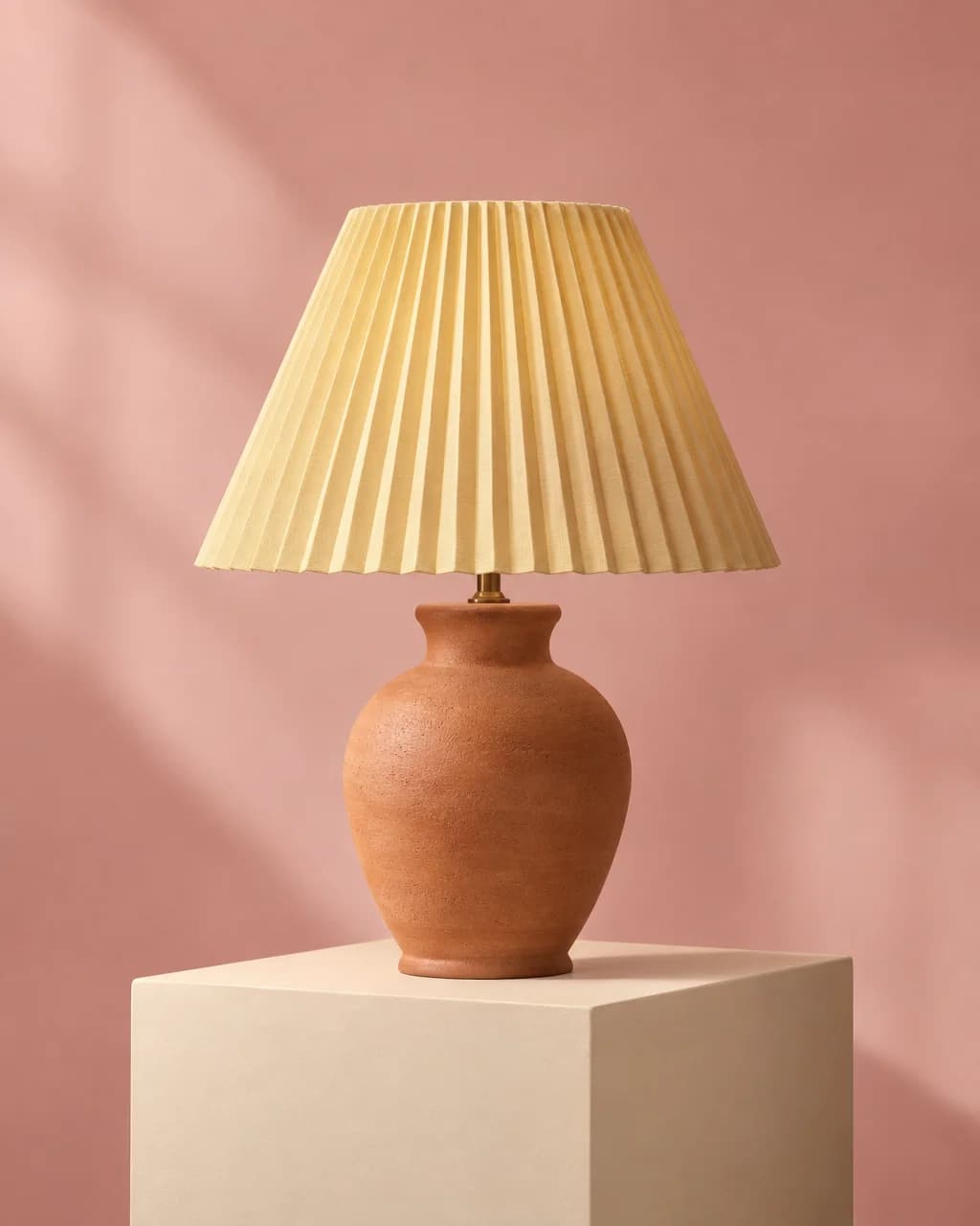 Fictional terracotta lamp with a pleated shade in a studio