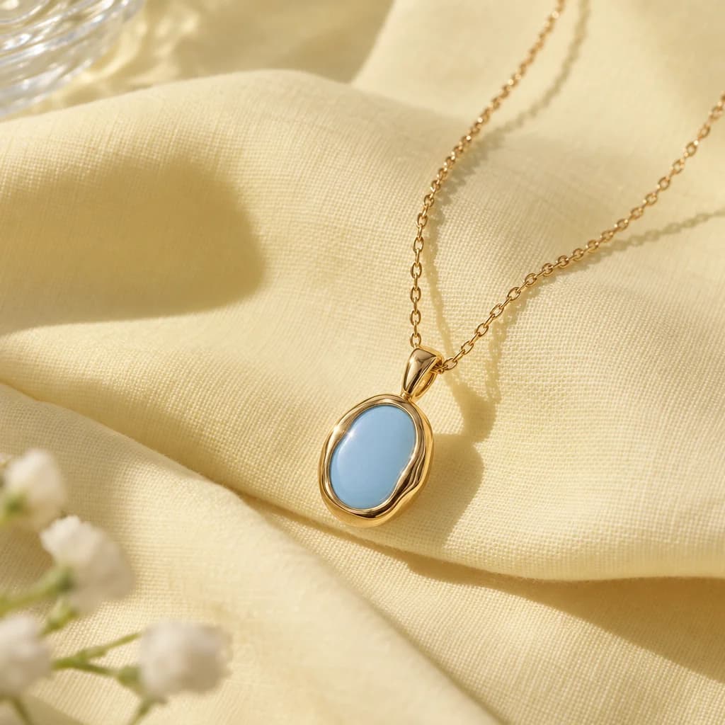 Close view of a fictional gold pendant on folded fabric