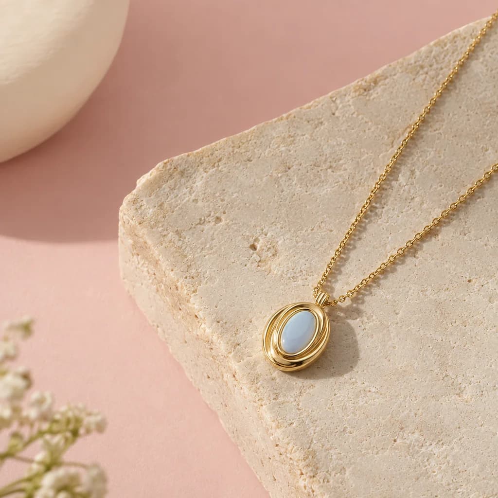 Fictional gold and pale-blue pendant in a studio setting